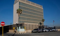 concrete building with parking lot in front, against a blue sky