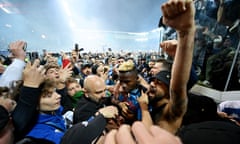 Victor Osimhen is mobbed by fans after his goal secured the draw that Napoli needed to win the Scudetto.