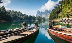 Long tail boats, Khao Sok National Park<br>Khao Sok National Park, Thailand - April 20, 2014: View from Prai Wan Raft Houses of moored long tail boats and lakeside cabins on Cheow Lan Lake in the heart of Khao Sok National Park in Surat Thani Province, Southern Thailand