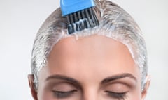 Young woman applying hair color<br>GettyImages-109233644