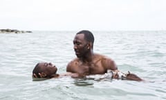 This image released by A24 shows Alex Hibbert, foreground, and Mahershala Ali in a scene from the film, "Moonlight." The Producers Guild of America has nominated awards season favorites “La La Land,” “Moonlight” and “Manchester by the Sea” for its top award, as well as the R-rated superhero film “Deadpool.” Winners will be announced in a Jan. 28 ceremony in Beverly Hills, Calif. (David Bornfriend/A24 via AP)