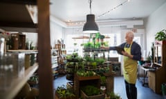 Terrarium shop owner taking inventory with clipboard