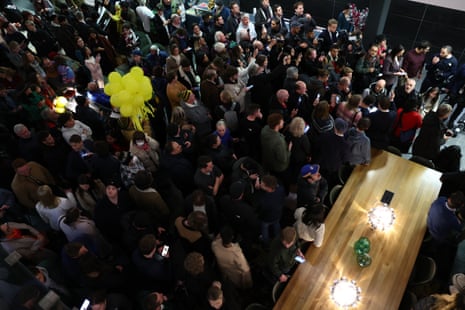 Supporters of WikiLeaks founder Julian Assange gather in the foyer of the hotel where he is staying in Canberra.