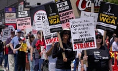 Protesters supporting the Hollywood writers' strike march outside an entrance to Boston University.