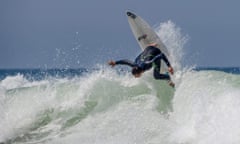 A surfer wearing a Picture Organic wetsuit