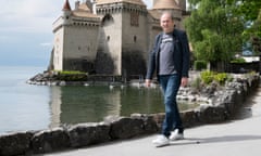 Man walking next to lake.