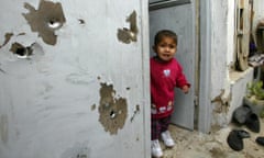 Child in bullet-riddled doorway