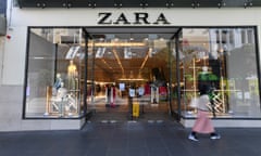 A person is seen walking past a Zara store in Melbourne.