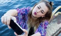 young woman by the waterfront taking a selfie<br>F0C43H young woman by the waterfront taking a selfie