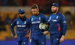 Adil Rashid, Jos Buttler and Jonny Bairstow leave the field after an eight-wicket loss in Bengaluru.