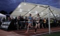 Night of the 10,000m PBs<br>Beth Potter and Steph Twell emerge from the beer tent on the home straight during the British womens 10,000 metres championship part of the Night of the 10,000m personal bests at Parliament Hill athletics track on May 20th 2017 in London (Photo by Tom Jenkins) FOR SPORT 2.0 PROJECT