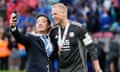 Leicester City chairman Aiyawatt Srivaddhanaprabha takes a selfie with Kasper Schmeichel.