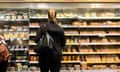 Woman looking at shelves of sandwiches in Tesco