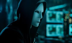 Masked Hacktivist Organizes malware Virus Attack on Global Scale. Hacker in Underground Secret Location Surrounded by Displays and Cables.