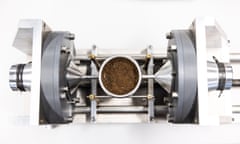 Top view of a scientific looking contraption that holds a container of ground coffee beans