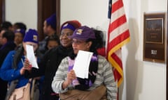 Furloughed contract workers hold unpaid bills to present to the office of the Senate majority leader, Mitch McConnell, 16 January.