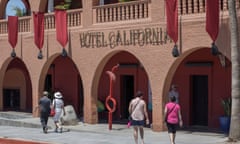 Tourists walk past Hotel California in the town of Todos Santos, Baja California Sur.