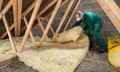 Homeowner upgrading loft insulation in domestic dwelling roof space