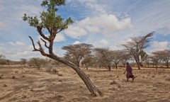 A man crosses arid land in western Turkana, Kenya
