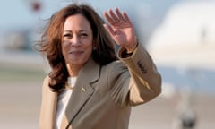 Kamala Harris waves after getting off a plane