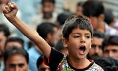 A child shouts during a protest against a police officer who shot dead a local teenager in the Kashmir Valley