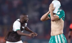 The Algeria forward Baghdad Bounedjah covers his face after his side’s defeat by Mauritania at Stade de la Paix in Bouake