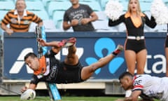 Corey Thompson of the Tigers scores the match winning try against the Roosters at ANZ Stadium in Sydney.