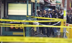 New York City police gather at the entrance to a subway stop in Brooklyn on 12 April 2022.