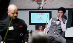 Luca Brecel in foreground with Si Jiahui slumped in his chair at the Crucible