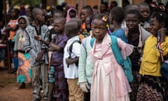 Schoolchildren in Ouagadougou, Burkina Faso, wait outside their school before classes start.