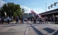 protesters crossing a city street with flags