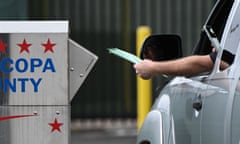 A driver drops off multiple early-voting ballots into a drop box in Maricopa county on 3 November 2022.