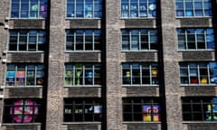 Images created with Post-it notes are seen in the windows of offices at 75 Varick Street in lower Manhattan