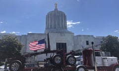 FILE - In this June 12, 2019, file photo, a truck moves around the Oregon state Capitol during a protest against climate bills that truckers say will put them out of business, in Salem, Ore. Oregon is on the precipice of becoming the second state after California to adopt a cap-and-trade program, a market-based approach to lowering the greenhouse gas emissions behind global warming. (AP Photo/Sarah Zimmerman, File)