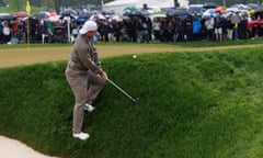 Rory McIlroy attempts to chip onto the 6th green from a steep bank after missing the green with his approach shot