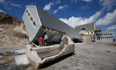 Local residents look inside a collapsed coastal house in the wake of Hurricane Irma in Vilano Beach, Florida.