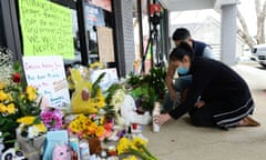 Jami Webb and her fiance Kevin Chen light candles outside Young’s Asian Massage. Webb is the daughter of Xiaojie Tan, the owner of the spa who was killed in the Atlanta shootings. 