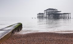 Brighton Beach and the remains of the old West Pier on a foggy day in flat light, Sussex, England.