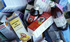 A pile of cough syrup bottles and boxes