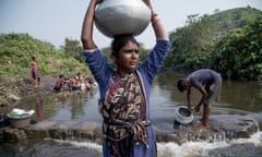 Beauty Devi and her son fetching water