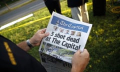 Steve Schuh, James Wolfe<br>Steve Schuh, county executive of Anne Arundel County, holds a copy of The Capital Gazette near the scene of a shooting at the newspaper’s office, Friday, June 29, 2018, in Annapolis, Md. A man armed with smoke grenades and a shotgun attacked journalists in the building Thursday, killing several people before police quickly stormed the building and arrested him, police and witnesses said. (AP Photo/Patrick Semansky)
