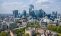 the City of London, with the modern skyscrapers in the background and the Tower of London in the foreground