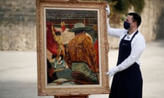 Employee poses with the 1941 painting "La Corrida (Le Matador dans l'arene)" (The Matador in the Arena)