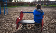 Small boy playing alone in a park