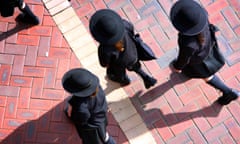 School students wearing large hats on an excursion