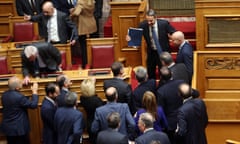 Kyriakos Mitsotakis is congratulated by his MPs after defeating the censure motion