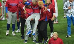 Edwin Diaz  is helped off the field after being injured during on-field celebrations