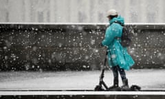 Riding an electric scooter through the snow.