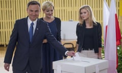 Andrzej Duda, the presidential candidate challenging the incumbent Bronisław Komorowski, casts his vote with his wife and daughter.
