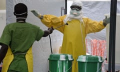 A health worker is decontaminated at the medical center of humanitarian organisation Doctor Without Borders (Medecin sans Frontiere (MSF)) in Monrovia on September 26, 2014 where people infected with the Ebola virus are treated. 